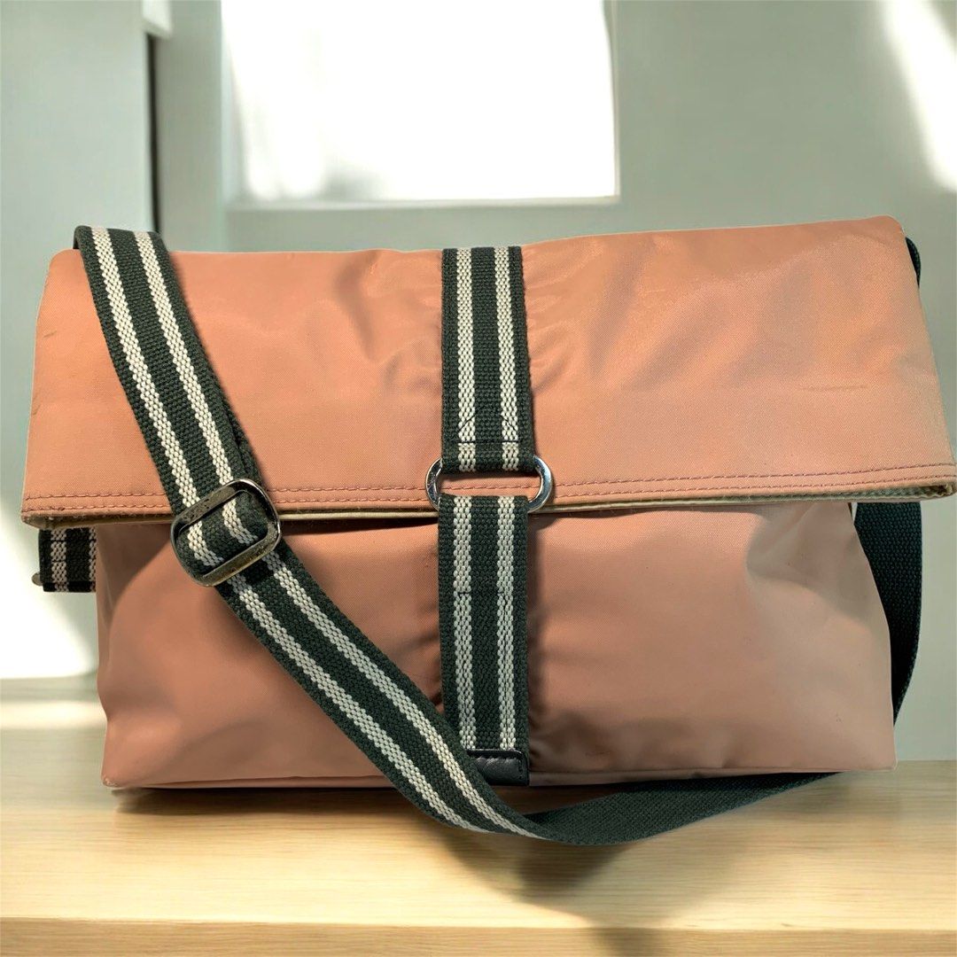 Agnes B. Voyage Shoulder Bag (Category: Shoulder Bags) located in Pasay City. Submitted by onick_79 (Listing ID 1403607342, Image 1). Description: Agnes B. Voyage Blush Pink Shoulder Bag Chic and feminine blush pink shoulder bag from Agnes B. Voyage. Features a flap closure, striped dark green and white strap, and a zip pocket on the back. The interior is spacious with a matching lining and logo detail inside. Measurement: L 38 × H 26 × W 9 cm St