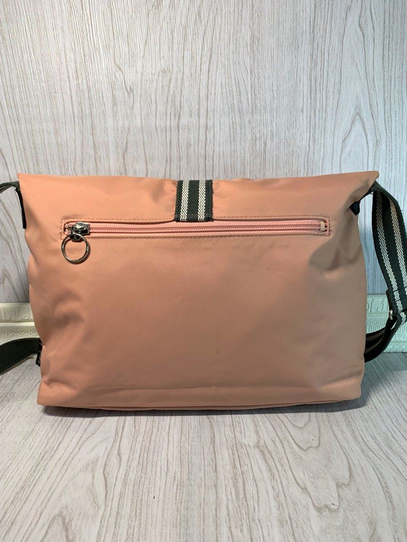 Agnes B. Voyage Shoulder Bag (Category: Shoulder Bags) located in Pasay City. Submitted by onick_79 (Listing ID 1403607342, Image 3). Description: Agnes B. Voyage Blush Pink Shoulder Bag Chic and feminine blush pink shoulder bag from Agnes B. Voyage. Features a flap closure, striped dark green and white strap, and a zip pocket on the back. The interior is spacious with a matching lining and logo detail inside. Measurement: L 38 × H 26 × W 9 cm St