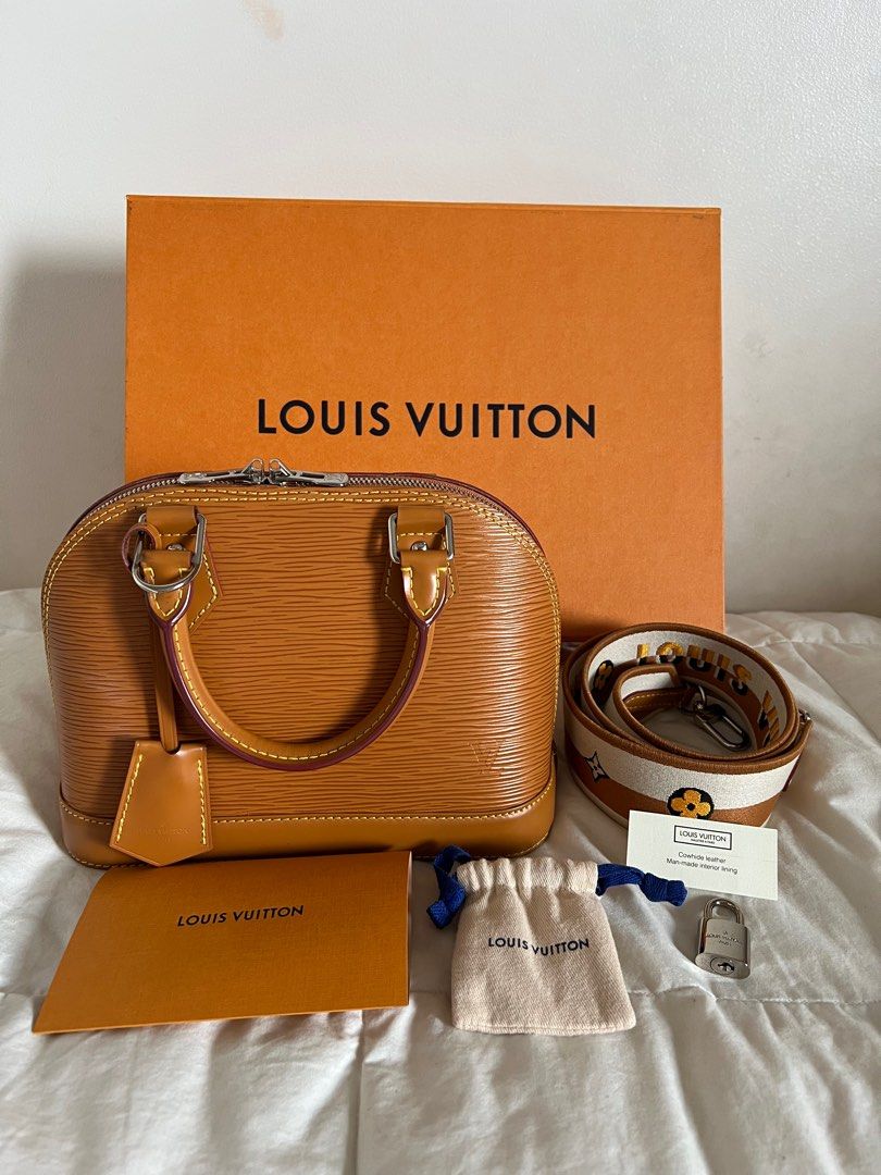 Authentic Louis Vuitton Alma BB Gold Miel (Category: Luxury Bags & Wallets) located in Mandaluyong City. Submitted by samg0602 (Listing ID 1403435280, Image 2). Description: - Authentic Louis Vuitton Alma BB handbag - Color: Gold Miel - Includes: Original box, dust bag, lock with keys, detachable strap - Features: Top handle, zip closure - Design: Structured shape, classic style - Condition: Clean interior, like new Bought in Paris with Proof of 