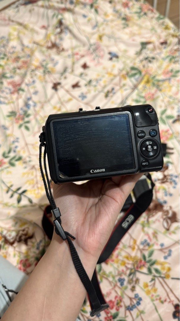 Canon EOS M Camera with 18-55mm Lens (Category: Cameras) located in Makati City. Submitted by xianii (Listing ID 1403459861, Image 3). Description: SELLING: - Canon EOS M camera (black body) - Includes 18-55mm lens with UV filter - Comes with charger and battery - Includes camera strap, 2 batteries, and battery charger - Features a screen on the back - Lens has focal length markings RFS: camera upgrade Price negotiable to sure buyers, DM if inter