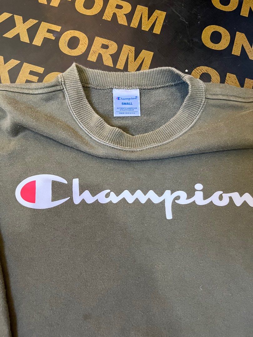 Champion Script Logo Crewneck (Category: Hoodies) located in Manila. Submitted by codearchivez (Listing ID 1403532542, Image 2). Description: Champion Script Crewneck (Army Green) Size: Small Condition: Excellent — soft, comfy, and well-kept. Classic everyday essential. — #CodeArchiveFinds #Champion #Streetwear #Essentials.
