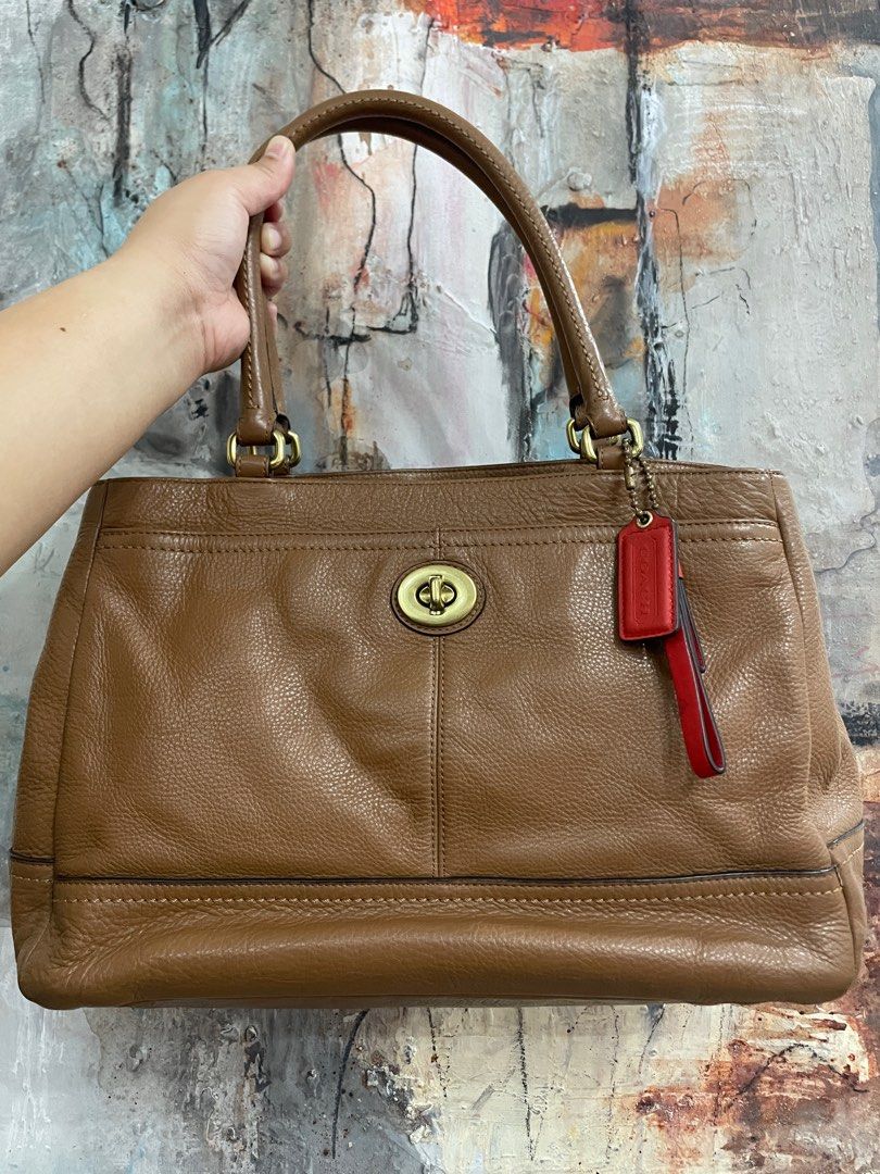 Coach Brown Leather Handbag (Category: Luxury Bags & Wallets) located in Las Pinas. Submitted by thingsupforgrab (Listing ID 1403535299, Image 1). Description: - Authentic Coach handbag - Bought in Japan - Brown leather - Top handle design - Turn-lock closure - Includes Coach hangtag - Bright orange interior lining with small ink stain; kindly check last photo - Comes with care instructions card - Classic, structured shape - Exterior pockets.