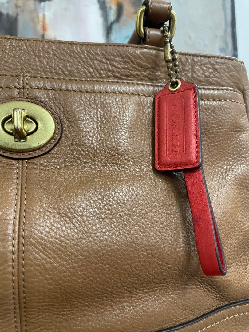 Coach Brown Leather Handbag (Category: Luxury Bags & Wallets) located in Las Pinas. Submitted by thingsupforgrab (Listing ID 1403535299, Image 3). Description: - Authentic Coach handbag - Bought in Japan - Brown leather - Top handle design - Turn-lock closure - Includes Coach hangtag - Bright orange interior lining with small ink stain; kindly check last photo - Comes with care instructions card - Classic, structured shape - Exterior pockets.