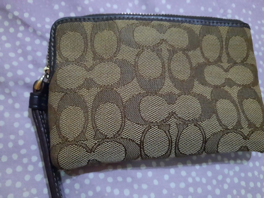 Coach Signature Wristlet (Category: Luxury Bags & Wallets) located in Manila. Submitted by anythingoesph (Listing ID 1403607454, Image 3). Description: - Coach wristlet - Signature brown and tan pattern - Wrist strap included - Secure zip closure.