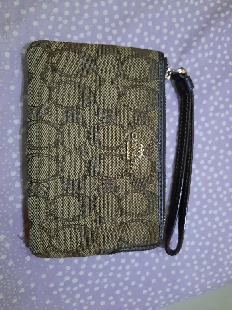 Coach Signature Wristlet (Category: Luxury Bags & Wallets) located in Manila. Submitted by anythingoesph (Listing ID 1403607454, Image 1). Description: - Coach wristlet - Signature brown and tan pattern - Wrist strap included - Secure zip closure.