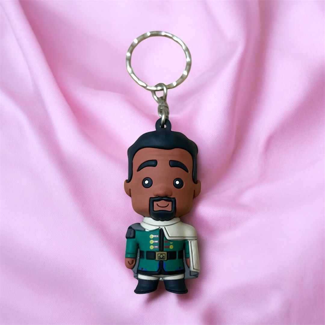 Disney Frozen M.I. Keychain (Category: Character Goods) located in Calamba. Submitted by thepinkpicksee (Listing ID 1403518213, Image 1). Description: - Disney character keychain - Features a character in green and white outfit - Silver ring included - Authentic Disney product - Collectible item - Disney logo and manufacturing details on the back.