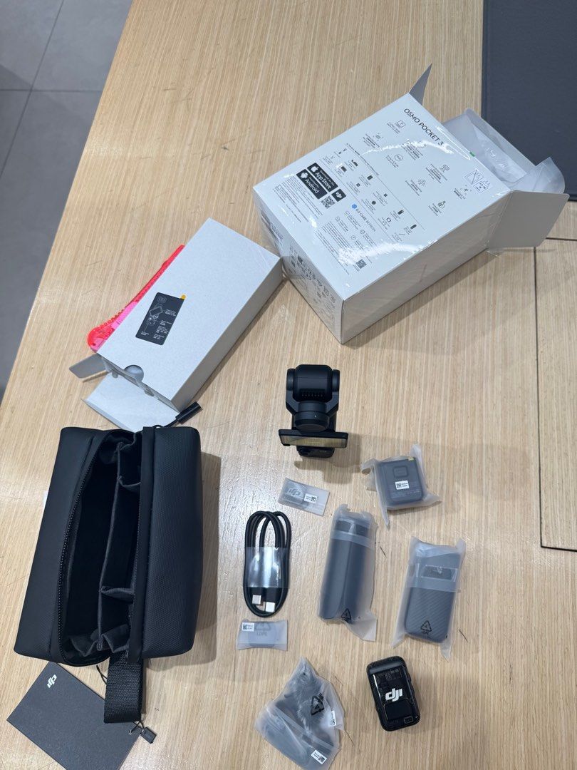 DJI Osmo Pocket 3 (Category: Cameras) located in Manila. Submitted by bestfindsbynes (Listing ID 1403576634, Image 3). Description: DJI Osmo Pocket 3. Includes the camera, a carrying case, a tripod, charging cable, and other accessories. Comes with the original box. The camera is black. With receipt bought at DJI megamall and warranty is still covered. .