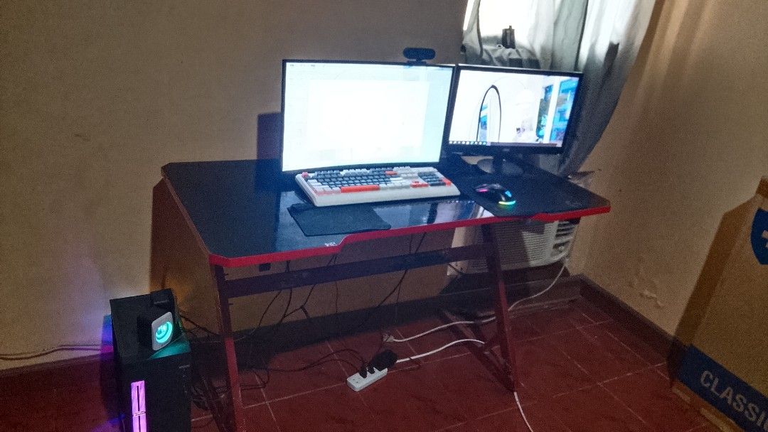 Gaming PC Setup with Dual Monitors (Category: Desktops) located in Santa Cruz, Pampanga. Submitted by juliajalan05857 (Listing ID 1403467319, Image 1). Description: specs PC Tower AMD A8-7680 (Radeon R7), 16 GB RAM, Windows 10 Pro — older gen but still good for office/school/light gaming Monitor 1 (AOC) 22″–24″, 1080p Monitor 2 (ViewPoint) similar size/spec Gaming Table mid-size, red-black edges, good condition RGB Keyboard + Mouse + Mousepad + W