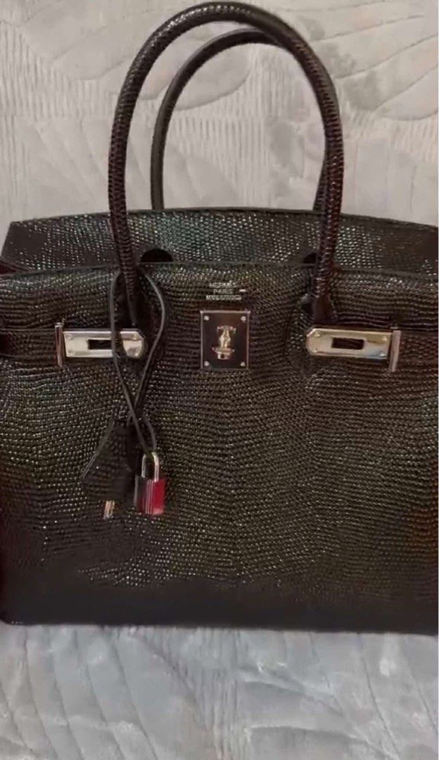 Hermes Black Lizard Skin Handbag (Category: Luxury Bags & Wallets) located in Manila. Submitted by frank444 (Listing ID 1403566067, Image 1). Description: - Black handbag with lizard skin texture - Classic design with top handles - Secure lock closure - Silver-tone hardware - Features Hermes logo - Includes matching lock and key - Stylish and sophisticated accessory.