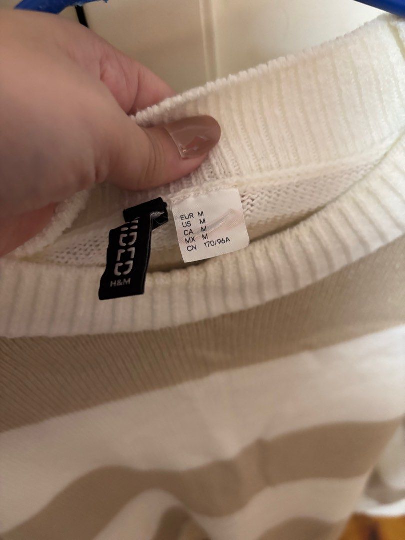 H&M Divided Striped Sweater - Size M (Category: Longsleeves) located in Quezon City. Submitted by cccarla_bc (Listing ID 1403489386, Image 3). Description: - H&M Divided sweater - Size: M - Color: White and beige stripes - Neckline: Crew neck - Sleeves: Long sleeves - Material: Knit.