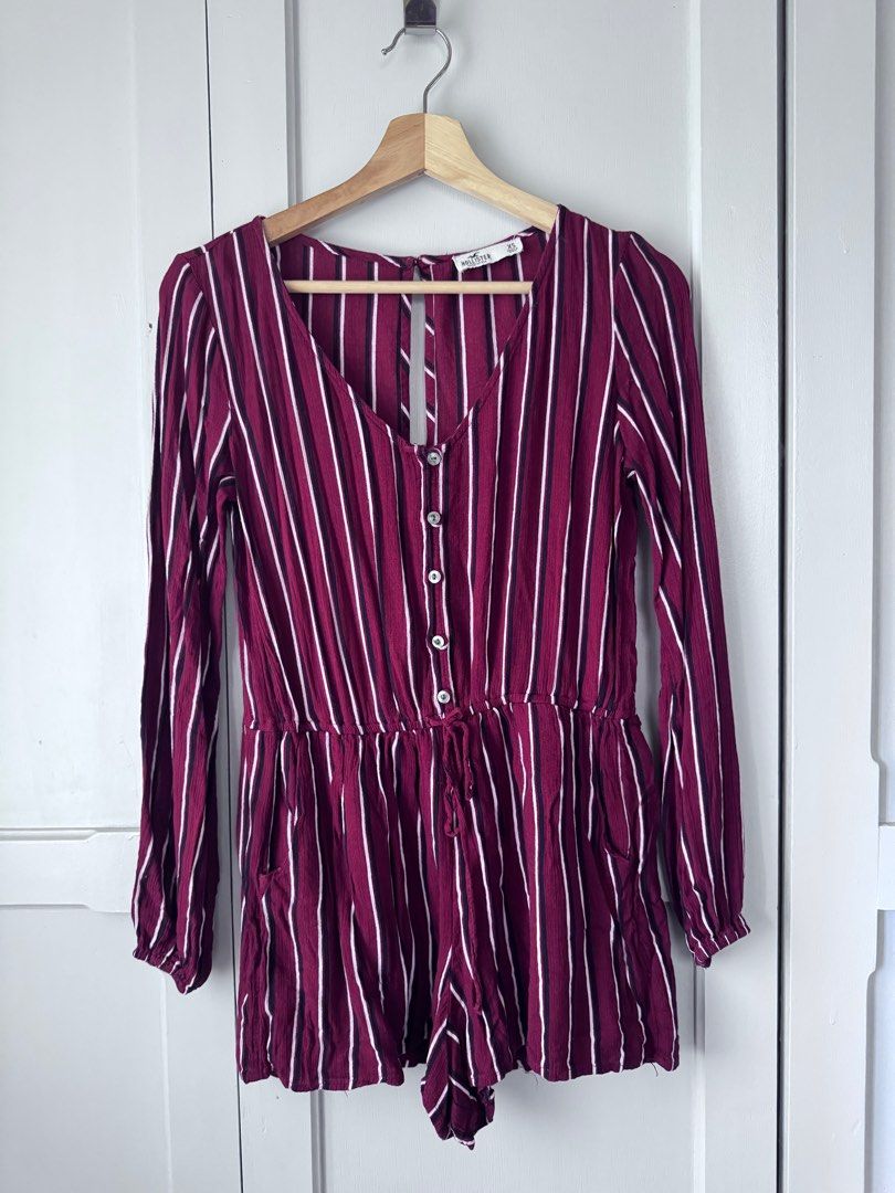 Hollister Striped Romper Fits M (Category: Rompers) located in Baguio. Submitted by makemegeli (Listing ID 1403487548, Image 1). Description: Hollister romper in a burgundy and white striped pattern. Features long sleeves, a V-neckline, and a drawstring waist. Includes pockets. The romper has a keyhole back and button details down the front. Size XS but can fit up to Medium. Very comfy, flowy material. .