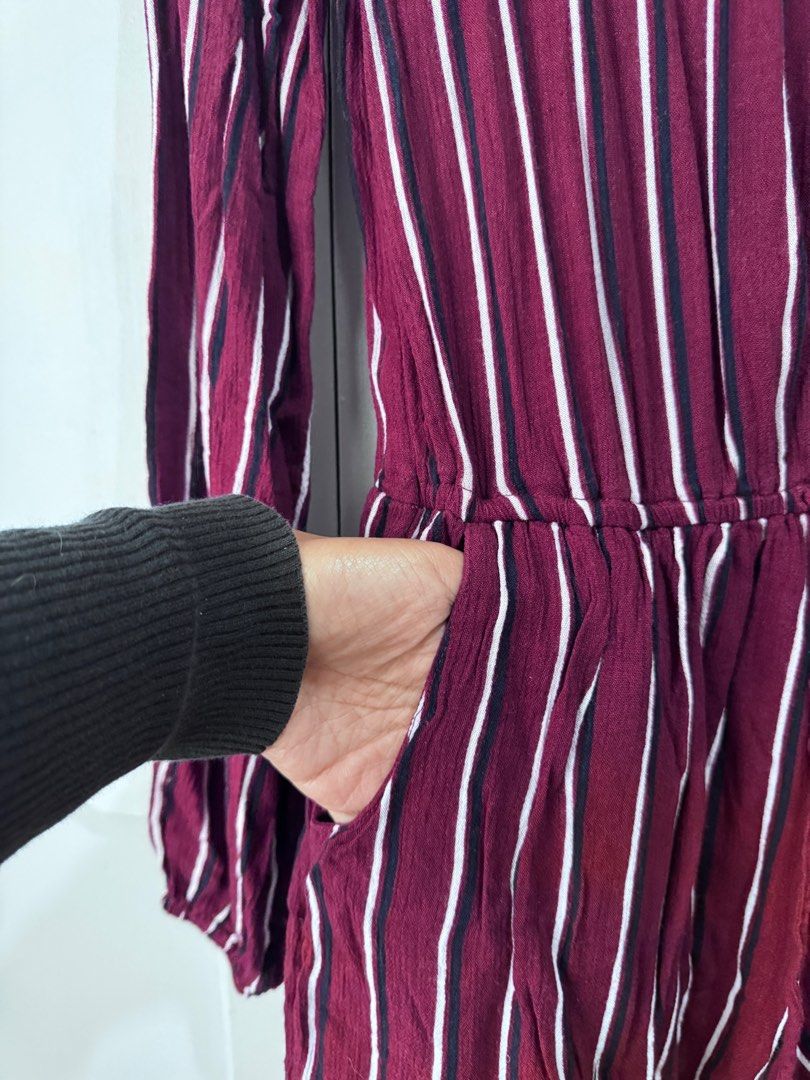Hollister Striped Romper Fits M (Category: Rompers) located in Baguio. Submitted by makemegeli (Listing ID 1403487548, Image 3). Description: Hollister romper in a burgundy and white striped pattern. Features long sleeves, a V-neckline, and a drawstring waist. Includes pockets. The romper has a keyhole back and button details down the front. Size XS but can fit up to Medium. Very comfy, flowy material. .