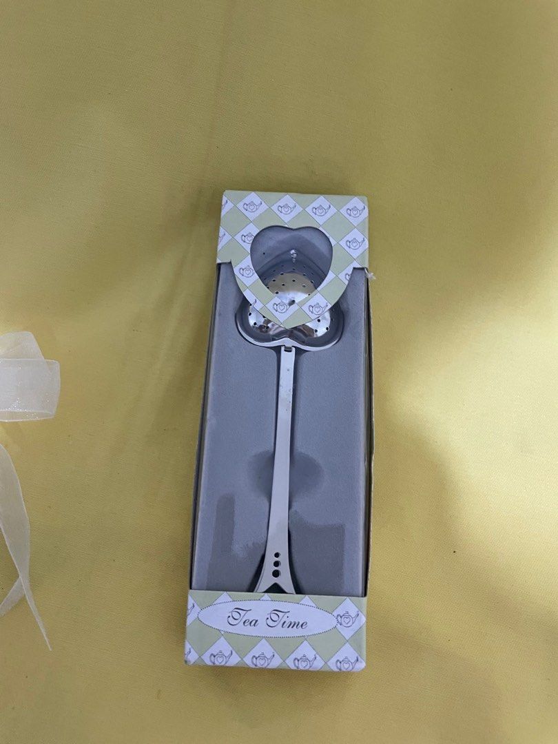 Kate Aspen Heart-Shaped Tea Infuser (Category: Coffee & Tea Tableware) located in Manila. Submitted by winnieyols (Listing ID 1403529176, Image 1). Description: Kate Aspen tea infuser is perfect for tea lovers! It features a heart-shaped infuser head and a long handle. The infuser comes in its original packaging, tied with a white ribbon. The box has a cute design with teapots and the words "Tea Time". -BRANDNEW - CAN BE USED AS TEA INFUSER OR PW