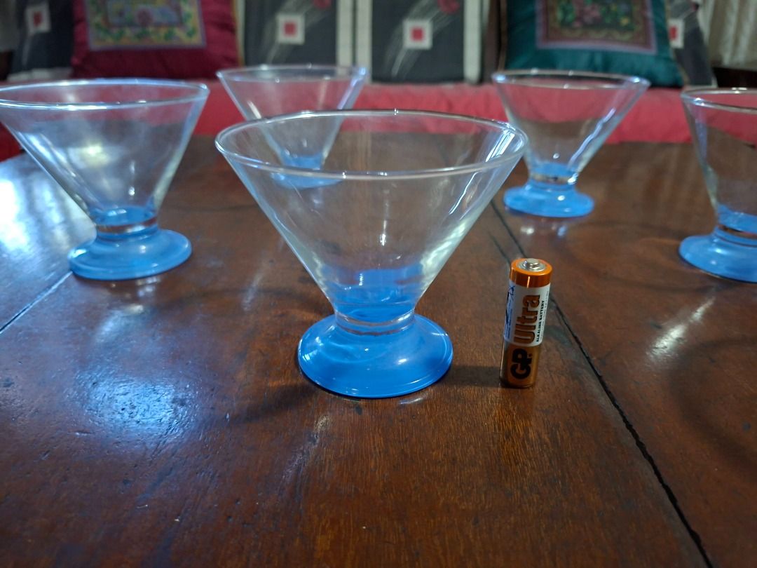 Martini glass (Category: Bakeware) located in Taguig. Submitted by d_man11 (Listing ID 1403567967, Image 2). Description: - Martini glasses - Classic martini shape - Features a blue base - Ideal for cocktails - In good condition - take all 8 pieces for only 400.