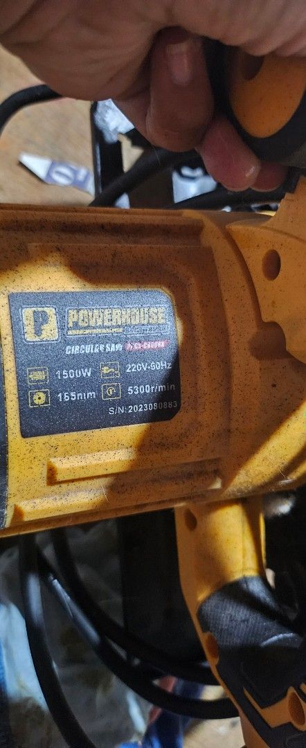 Powerhouse Circular Saw (Category: Construction Tools & Equipment) located in Manila. Submitted by SimplyandJustBy_Maidavao (Listing ID 1403570295, Image 3). Description: - Powerful circular saw - Black and yellow design - Includes saw blade - Comes with power cord - Features a handle for easy use.