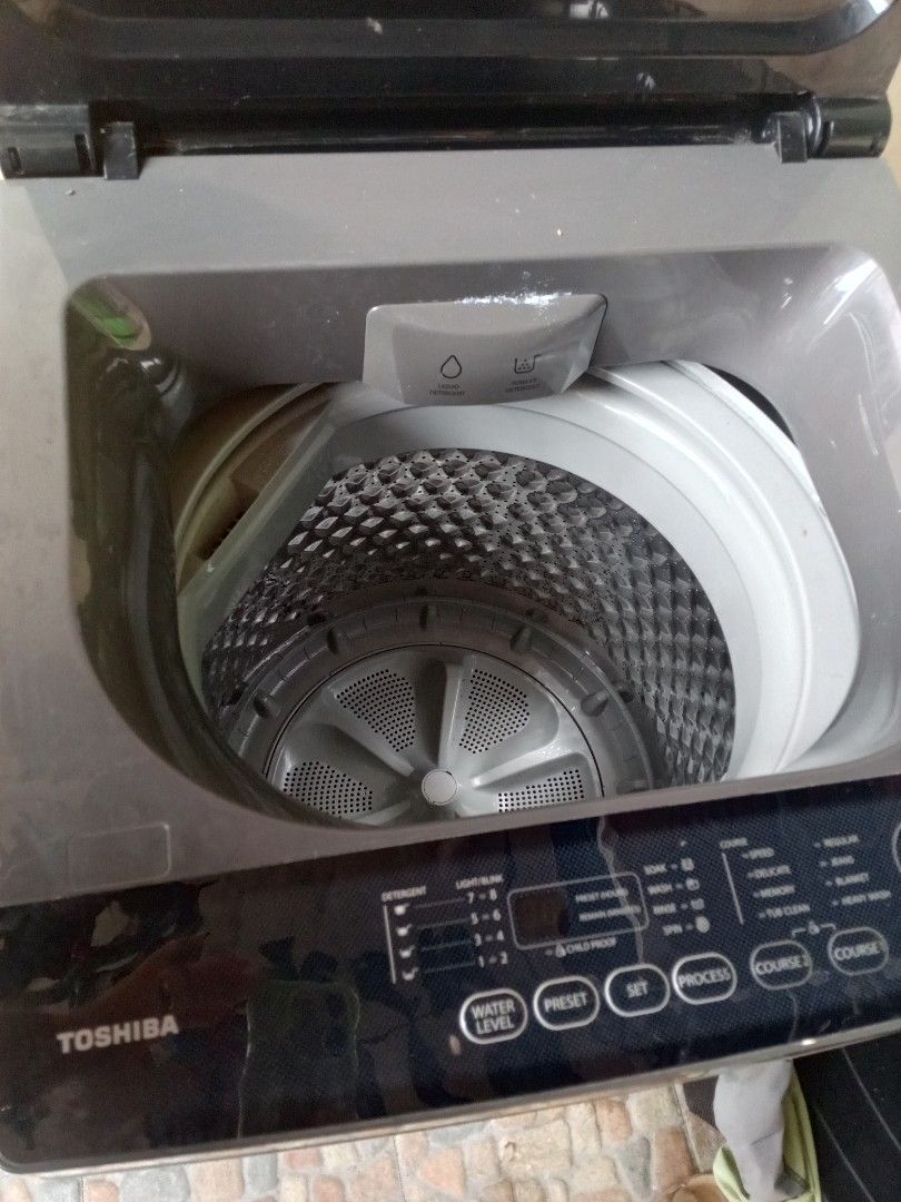 Toshiba Top Load Washing Machine 7kg (Category: Washing Machines and Dryers) located in Navotas City. Submitted by liverabbit_d3c8e3 (Listing ID 1403455309, Image 2). Description: - Toshiba 7kg Top Load Washing Machine - Stainless steel drum - Multiple wash cycle options - Dark gray finish - Glass lid - Efficient and effective cleaning.