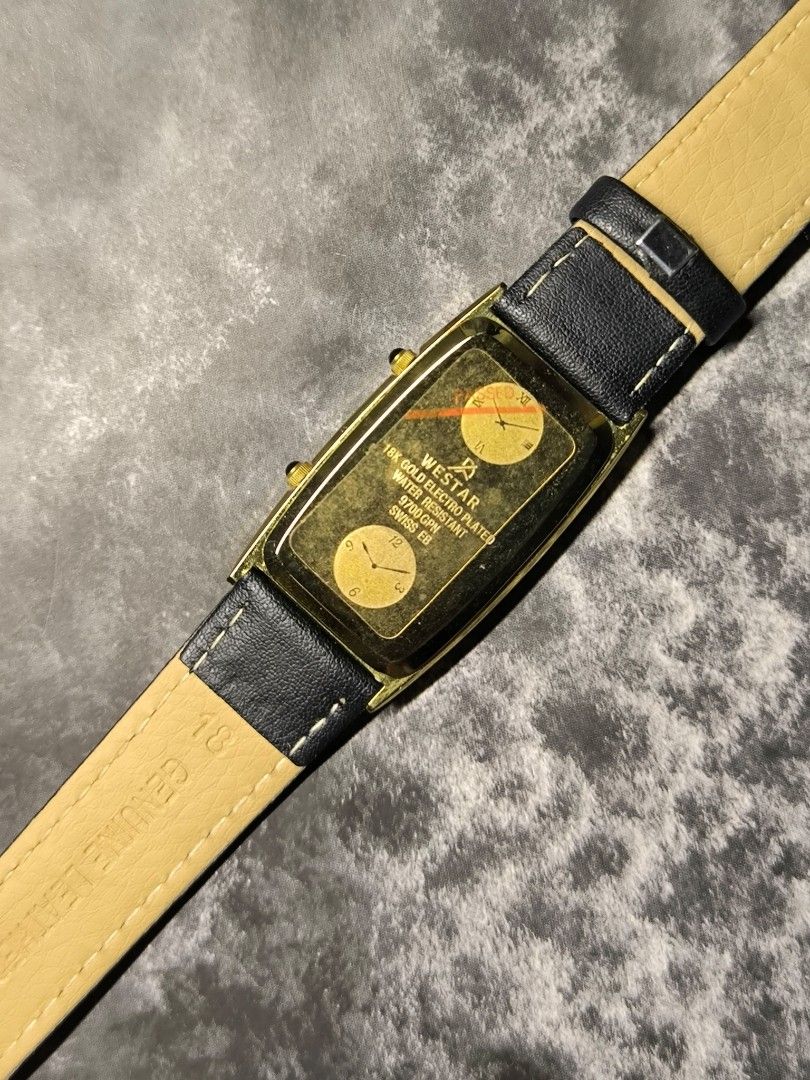 Westar Dual Time Watch with Leather Strap (Category: Women's Watches) located in Pasay City. Submitted by cassiuss (Listing ID 1403598097, Image 2). Description: Elegant Westar dual time watch with a rectangular gold-toned case. Features a white dial with two sub-dials and a black leather strap. The watch comes with its original box. The back of the watch case has the Westar brand name and other details. The strap is genuine leather..