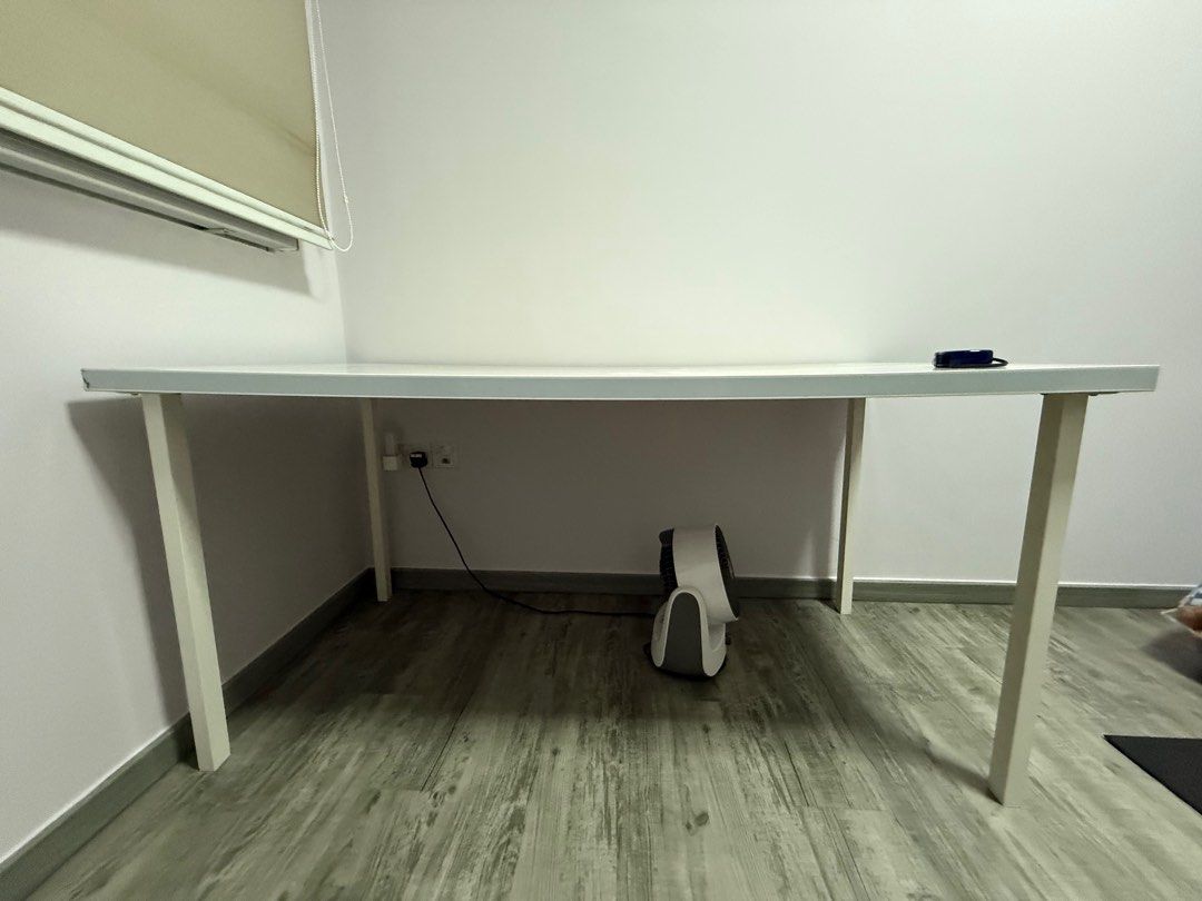 White Study Table (Category: Tables & Sets) located in Singapore. Submitted by herlinayeo (Listing ID 1403561972, Image 2). Description: - White study table - Ideal for small spaces - Minor signs of use - Sturdy and functional - Stable legs - 150 cm x 75cm.