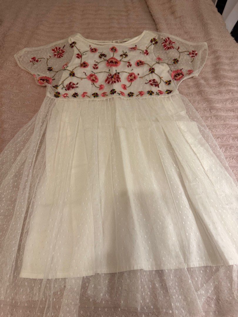 Zara Girls Embroidered Dress (Category: Dresses) located in Manila. Submitted by maryann22cabig (Listing ID 1403433467, Image 2). Description: Beautiful white dress from Zara Girls, featuring delicate floral embroidery. The dress has a round neckline and short sleeves. It is adorned with colorful floral embroidery on the bodice and a dotted tulle overlay. The size is 11/12. Perfect for special occasions or everyday wear..
