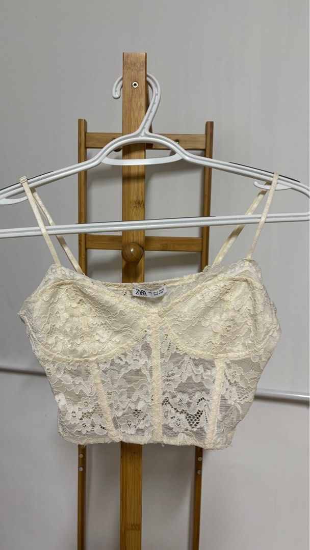 Zara Lace Bustier Corset Top (Category: Sleeveless) located in Pasig City. Submitted by decluttering.ring (Listing ID 1403538181, Image 1). Description: - Zara ivory lace bustier top - Adjustable spaghetti straps - Sweetheart neckline - Fitted silhouette - Cropped length - Great for layering or wearing alone - A versatile wardrobe essential - Used ONCE - Bought it for 1.2k.