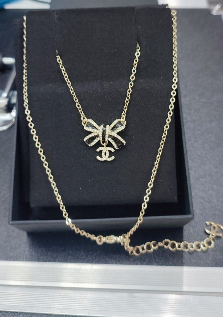 Authentic gold-tone Chanel CC pendant necklace (Category: Luxury Accessories) located in Caloocan City. Submitted by babe.mine (Listing ID 1403733284, Image 1). Description: Gold-tone Chanel CC pendant necklace featuring a bow motif and rhinestone embellishments.