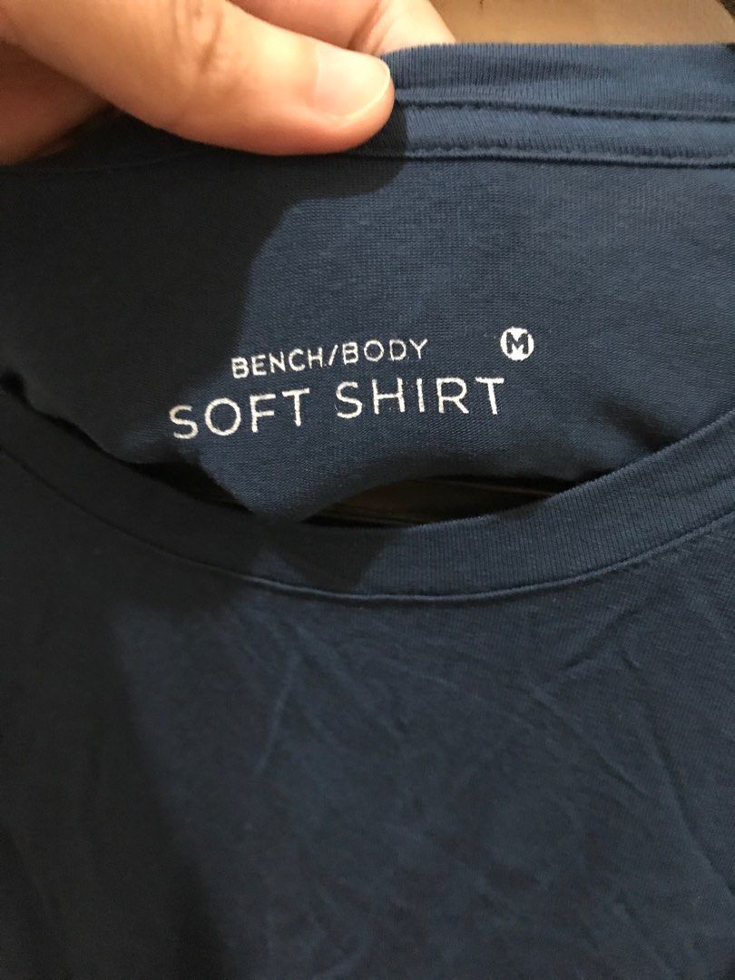 Bench/Body Soft Shirt - Navy Blue (Category: Shirts) located in Quezon City. Submitted by rozch (Listing ID 1403702105, Image 2). Description: - Brand: Bench - Color: Navy Blue - Style: Body Soft Shirt - Size: M - Neckline: Crew Neck - Sleeves: Short Sleeves - Material: Soft - Perfect for everyday wear - Versatile addition to your wardrobe.