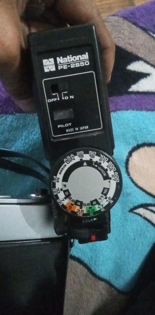 Canon QL Camera with National PE-2850 Flash (Category: Cameras) located in Manila. Submitted by chevyrede36083 (Listing ID 1403737391, Image 1). Description: - Vintage Canon QL camera - Canon SE 45mm 1:1.8 lens - National PE-2850 flash unit - Black leather case included - Flash features ASA/DIN dial and on/off switch - Made in Japan.