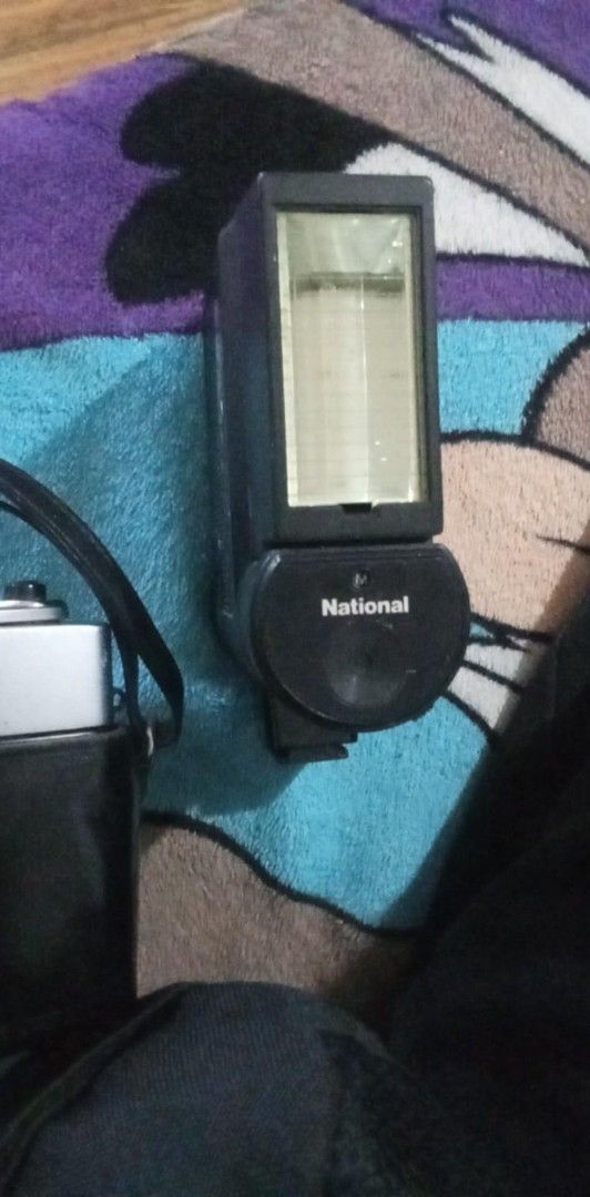 Canon QL Camera with National PE-2850 Flash (Category: Cameras) located in Manila. Submitted by chevyrede36083 (Listing ID 1403737391, Image 2). Description: - Vintage Canon QL camera - Canon SE 45mm 1:1.8 lens - National PE-2850 flash unit - Black leather case included - Flash features ASA/DIN dial and on/off switch - Made in Japan.