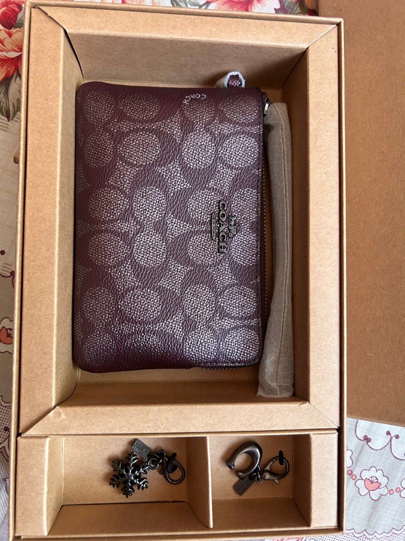 Coach Zip Wristlet with Charms Box Set (Category: Luxury Bags & Wallets) located in Makati City. Submitted by hannahsstufff (Listing ID 1403675469, Image 3). Description: Authentic Coach Zip Wallet in Mahogany/GunMetal with charms included (Coach C logo, Snowflake) in a box US-sourced Ideal for gifting, as it comes in a box *Coach paperbag included Other wallet items in box are also available (see last photos).