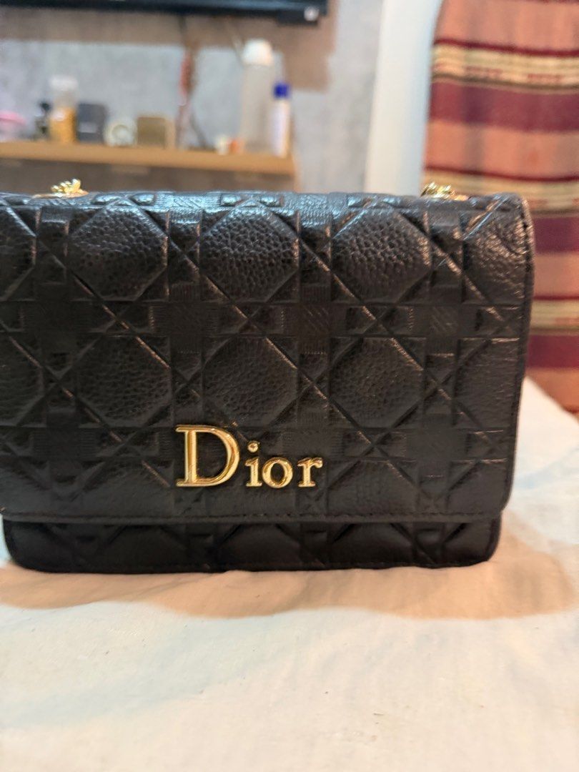 Dior Black Chain Bag (Category: Luxury Bags & Wallets) located in San Pedro. Submitted by jhoyce48 (Listing ID 1403636165, Image 1). Description: Black Dior chain bag with gold-tone hardware. Features a quilted design with the Dior logo on the front. The interior includes a compartment with a magnetic closure. The bag has a chain strap for shoulder or crossbody wear. The bag is made of leather. .