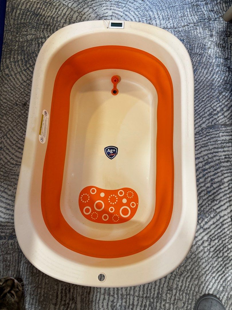 Foldable Baby Bathtub with Temperature Sensor (Category: Bathtub & Bath Accessories) located in Quezon City. Submitted by keropersi (Listing ID 1403669294, Image 1). Description: - Foldable baby bathtub - Orange and white design - Built-in temperature sensor - Non-slip base - Easy storage - Suitable for babies and toddlers Signs of usage Temp control not sure if working Gcash only Delivery c/o buyer .