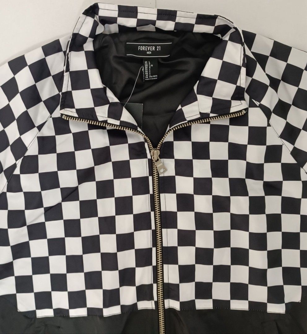 Forever 21 Checkerboard Jacket (Category: Activewear) located in Mandaluyong City. Submitted by bethco (Listing ID 1403632843, Image 3). Description: - Forever 21 jacket - Black and white checkerboard upper and sleeves - Solid black lower section - Full zip closure - Stand-up collar - Elastic cuffs and hem - Lined for warmth and comfort.
