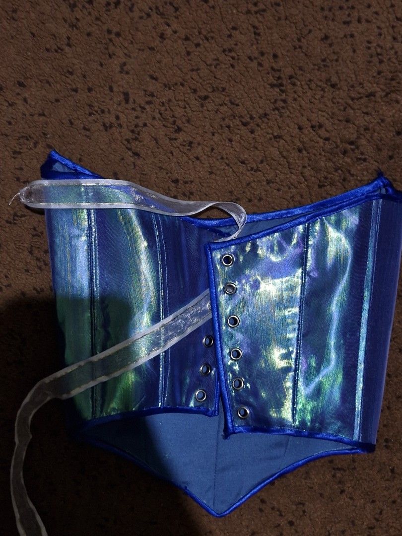 Iridescent Mermaid Blue Corset Top (Category: Others Tops) located in Manila. Submitted by jenina_ (Listing ID 1403789684, Image 2). Description: - Iridescent blue corset top - Unique color-shifting effect - Structured design with boning - Lace-up back - Vibrant blue with a hint of green - Includes ribbon for tying XS TO S Worn once for fitting RFS: Wrong design.