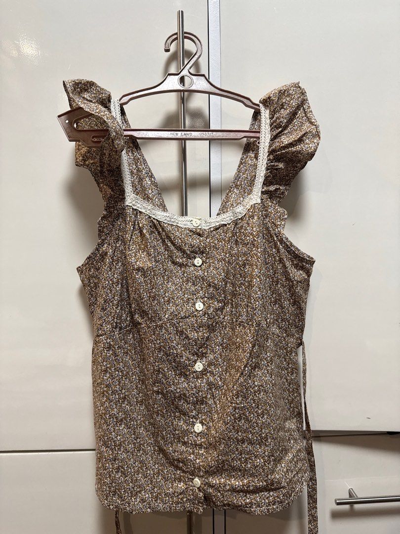 Just G Floral Top - XL (Category: Blouses) located in Bulacan. Submitted by shop.ny (Listing ID 1403790170, Image 1). Description: - Just G floral top - Size: XL - V-neckline with lace trim - Button details down the front - Ruffled sleeves - Waist tie - Neutral color - Small floral pattern.
