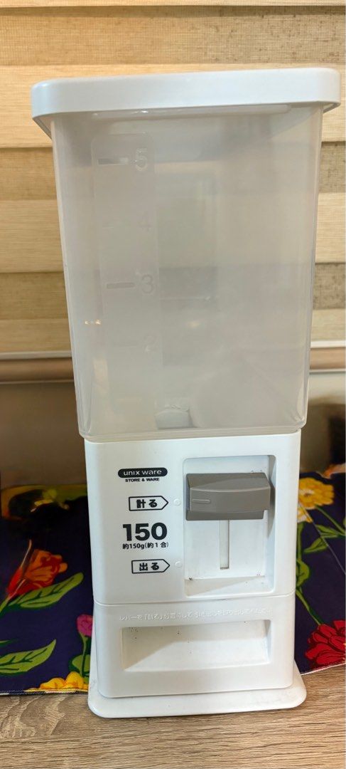 Minimalist Rice Dispenser (Category: Food Organization & Storage) located in Taguig. Submitted by wountersdam (Listing ID 1403682467, Image 3). Description: - designed to dispense approximately 1 cup of rice per serving - It has a clear container to easily monitor the rice level. - The dispenser features a simple lever mechanism for dispensing. - It is a practical and space-saving solution for storing and dispensing rice. -Can be assembled -Appro