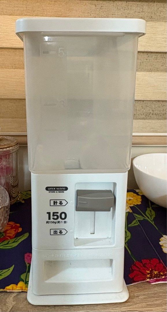 Minimalist Rice Dispenser (Category: Food Organization & Storage) located in Taguig. Submitted by wountersdam (Listing ID 1403682467, Image 1). Description: - designed to dispense approximately 1 cup of rice per serving - It has a clear container to easily monitor the rice level. - The dispenser features a simple lever mechanism for dispensing. - It is a practical and space-saving solution for storing and dispensing rice. -Can be assembled -Appro