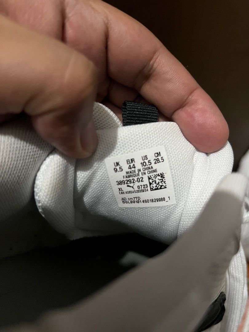 Puma 389292-02 White Sneakers (Category: Sneakers) located in Malabon City. Submitted by djvitv (Listing ID 1403724702, Image 3). Description: White Puma sneakers with black accents. Features a mesh upper and lace-up closure. The size is UK 9.5, EUR 44, and 28.5 cm. The sneakers have a thick white sole. The Puma logo is visible on the side..