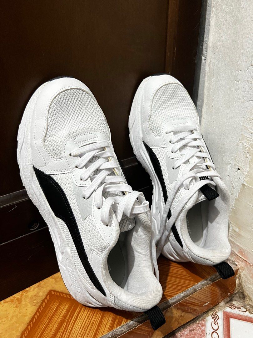 Puma 389292-02 White Sneakers (Category: Sneakers) located in Malabon City. Submitted by djvitv (Listing ID 1403724702, Image 1). Description: White Puma sneakers with black accents. Features a mesh upper and lace-up closure. The size is UK 9.5, EUR 44, and 28.5 cm. The sneakers have a thick white sole. The Puma logo is visible on the side..