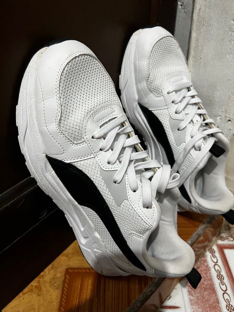 Puma 389292-02 White Sneakers (Category: Sneakers) located in Malabon City. Submitted by djvitv (Listing ID 1403724702, Image 2). Description: White Puma sneakers with black accents. Features a mesh upper and lace-up closure. The size is UK 9.5, EUR 44, and 28.5 cm. The sneakers have a thick white sole. The Puma logo is visible on the side..