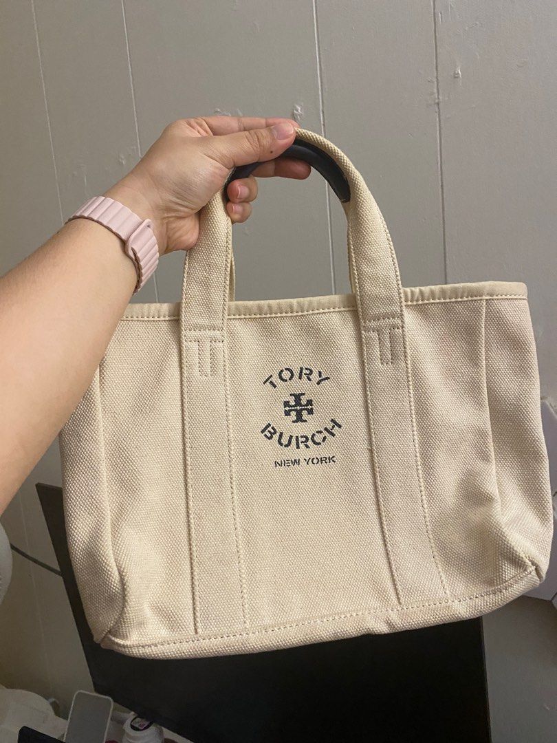 Tory Burch Canvas Mini Tote (Category: Luxury Bags & Wallets) located in Marikina City. Submitted by closetbycamille (Listing ID 1403709199, Image 1). Description: - Authentic Tory Burch mini tote bag - Canvas exterior with Tory Burch logo - Two top handles with leather accents - Interior pocket - Perfect for everyday use - Stylish and practical accessory.