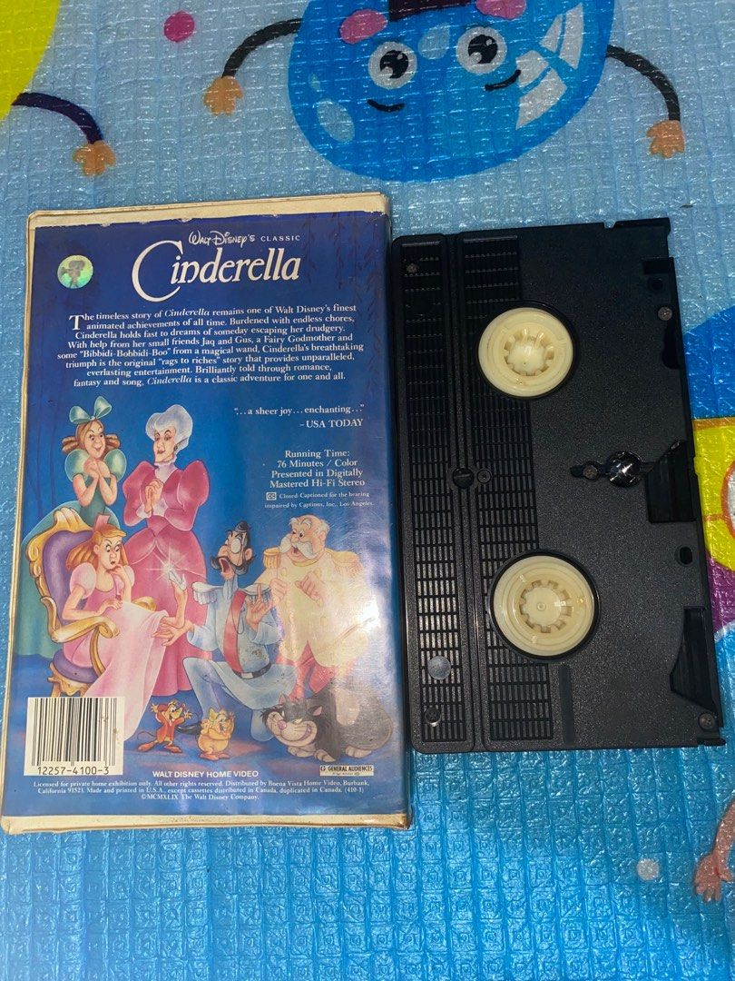 Walt Disney's Cinderella VHS Tape (Category: Storybooks) located in Manila. Submitted by mightytiger-7bca (Listing ID 1403760254, Image 2). Description: Classic Walt Disney's Cinderella VHS tape. Features the original animated classic. Includes the VHS tape and its original box. The box art features Cinderella, the Fairy Godmother, and other characters. The back of the box provides a synopsis and details about the movie. Running time is 76 minute