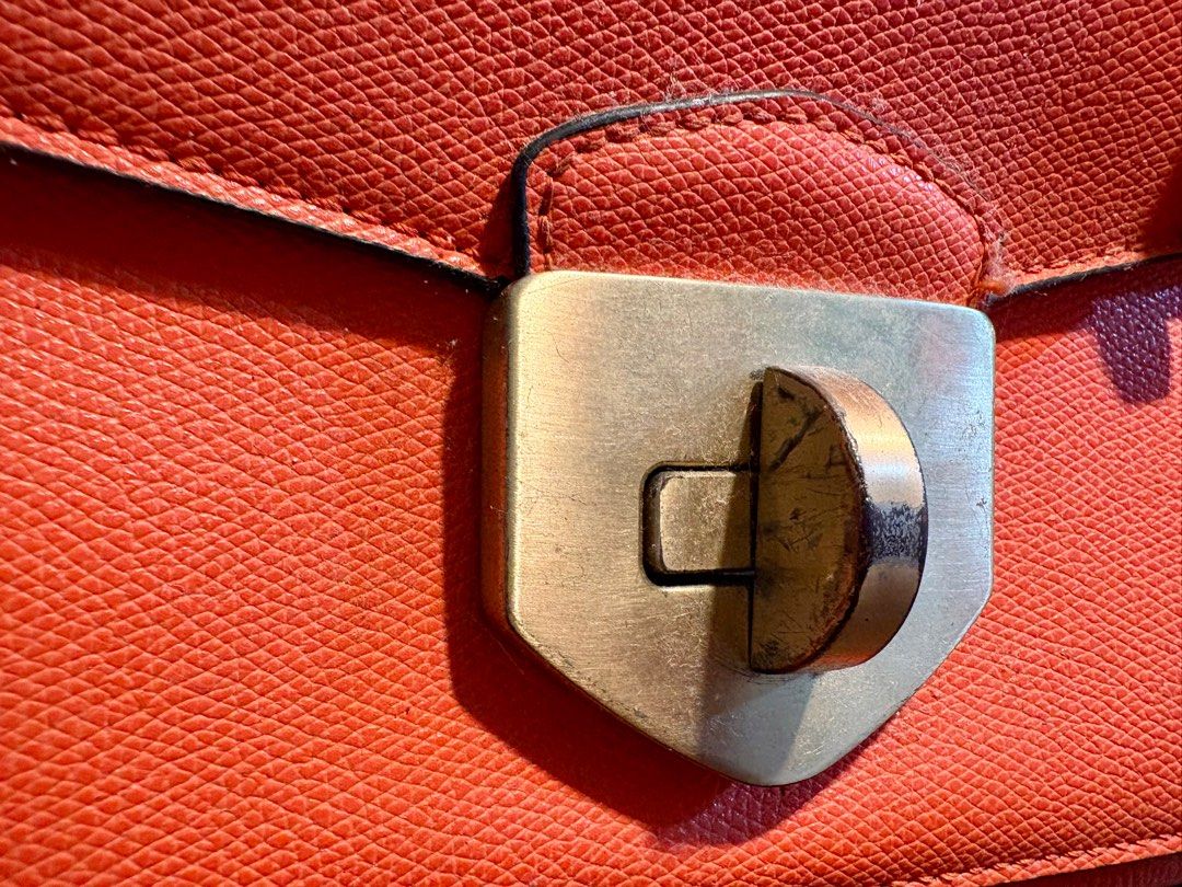 Aldo Handbag / Crossbody Bag (Category: Cross-body Bags) located in Taguig. Submitted by wountersdam (Listing ID 1403822039, Image 2). Description: Orange Aldo handbag that can be used as a handbag or crossbody bag. It is made of leather material and comes with a strap (leather and chain). The bag has a gold-colored clasp and a small gold chain with a charm. It has a handle on top and a flap closure. The bag can fit a lot. - Price slightly negoti