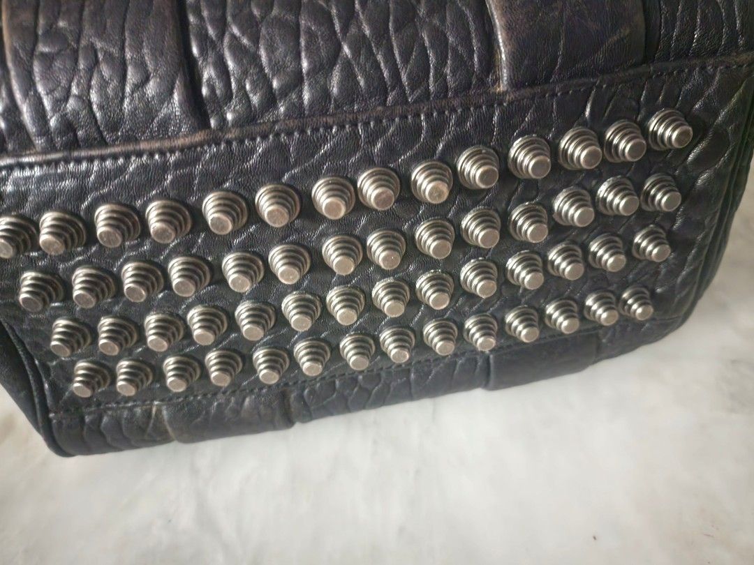 Alexander Wang Rocco Handbag Bag medium (Category: Luxury Bags & Wallets) located in Quezon City. Submitted by bbbts1268 (Listing ID 1403847558, Image 3). Description: - Rugged Black heavy textured leather handbag🤘 - Top handles - zip closure on top and side - antique brass hardware - Detachable shoulder strap, but missing loop/ band - signs of use 10 inches width 7 inches height not gucci marc jacobs michael kors h&m balenciaga prada zara uniql
