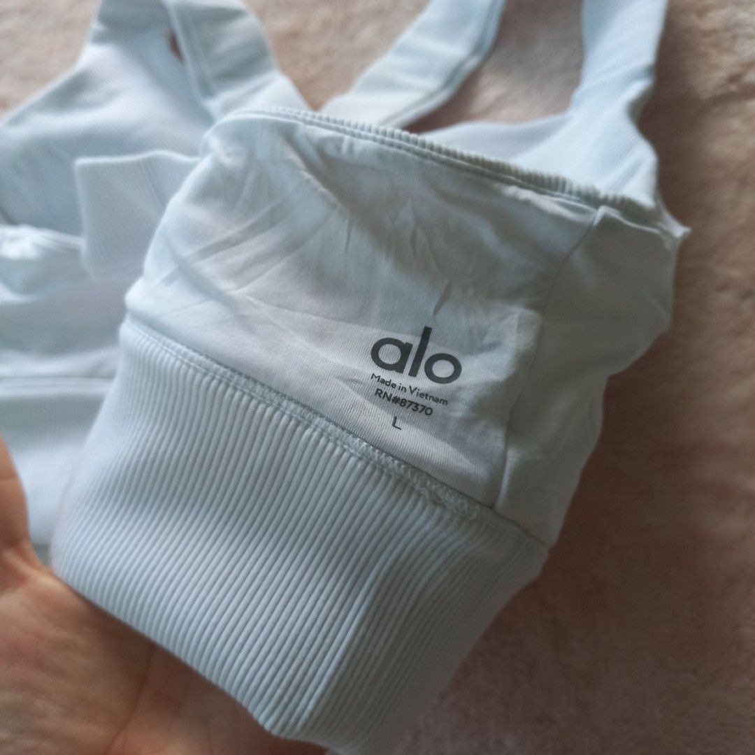Alo Yoga White Sports Bra (Category: Activewear) located in Santiago. Submitted by lastlastprice (Listing ID 1403826273, Image 3). Description: - Alo Yoga sports bra - Light blue color - Size: L - Criss-cross back design - Ribbed fabric - Made in Vietnam - Features the Alo logo - Condition: Like new issue: need lng ng wash nadumihan sa loob.