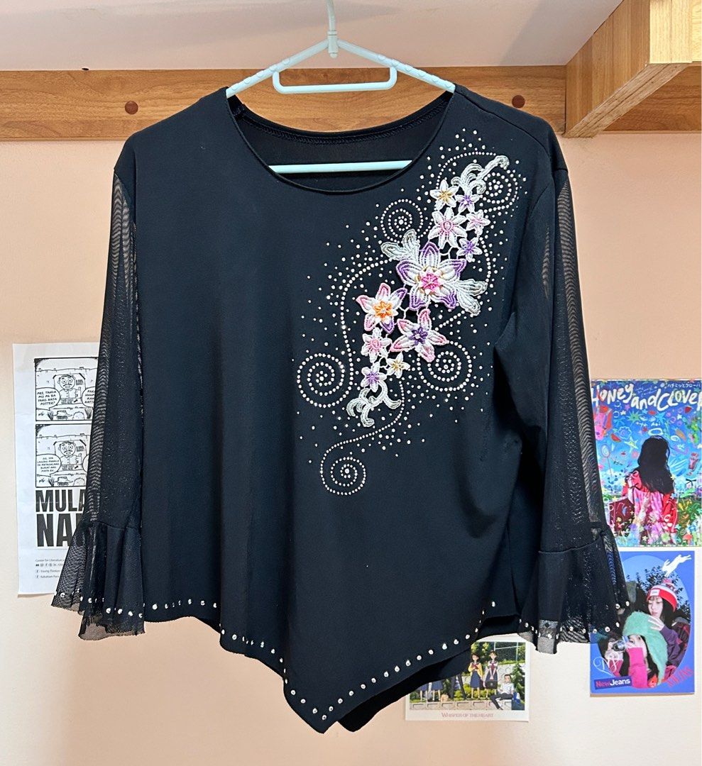 Black Embellished Blouse with Mesh Sleeves (Category: Blouses) located in Pasig City. Submitted by feryclo (Listing ID 1403931388, Image 1). Description: - Black blouse - Floral embellishments - Mesh sleeves with flared cuffs - Asymmetrical hemline - Sparkling details - Versatile for various occasions.
