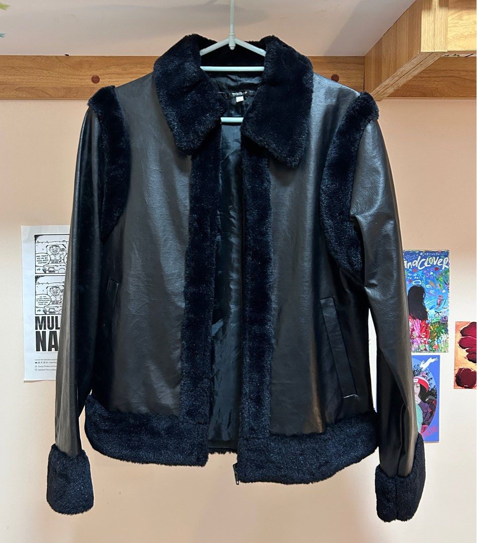 Black Faux Leather Jacket with Fur Trim (Category: Coats, Jackets and Outerwear) located in Pasig City. Submitted by feryclo (Listing ID 1403931921, Image 1). Description: - Black faux leather jacket - Fur trim detailing - Classic collar and cuffs with fur accents - Front zipper closure - Standard fit - Versatile for various occasions.