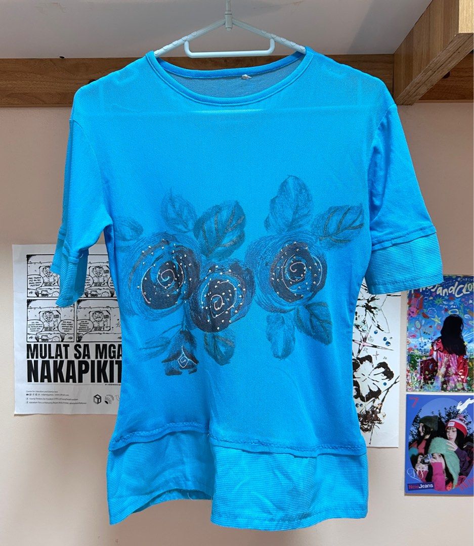 Blue Floral Print T-shirt (Category: Tshirts & Polo Shirts ) located in Pasig City. Submitted by feryclo (Listing ID 1403931706, Image 1). Description: - Blue t-shirt with a unique floral print. - Features short sleeves and a classic round neckline. - Stylish layered hemline. - Floral design in shades of blue and gray. - Made from a lightweight, comfortable material..