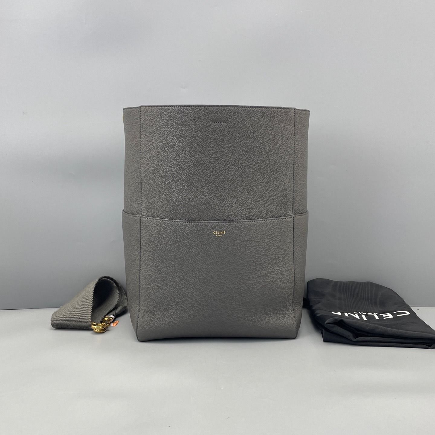 Celine Seau Sangle Bucket Bag in Grey GHW (Category: Bags & Wallets) located in Singapore. Submitted by projectlfg (Listing ID 1403854067, Image 2). Description: Celine Seau Sangle Bucket Bag in Grey GHW Condition 97% New. Year: - Accessories: Dust Bag Item code: A7172H Size: 23x34x17 / SGD: 879 / 1353399 • ACRA Registered Company in Singapore • Physical Outlets in Singapore and China • Entrupy Verified Business • Authenticity Guaranteed • Worldw