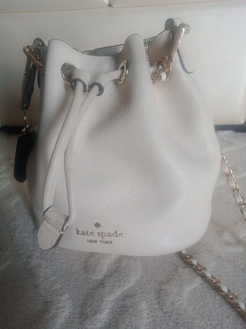 Kate Spade Mini Bucket Bag (Category: Luxury Bags & Wallets) located in Quezon City. Submitted by bakedmacarhona (Listing ID 1403830403, Image 2). Description: AUTHENTICITY, GUARANTEED! -Cream-colored Kate Spade mini bucket bag - Drawstring closure - Chain strap - Kate Spade New York logo on front - Interior pocket with Kate Spade label - Made of pebbled leather - Includes original tag Changed the strap for a more formal look. Will include the or