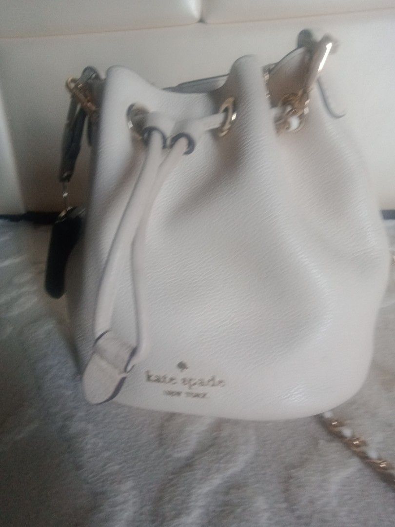 Kate Spade Mini Bucket Bag (Category: Luxury Bags & Wallets) located in Quezon City. Submitted by bakedmacarhona (Listing ID 1403830403, Image 1). Description: AUTHENTICITY, GUARANTEED! -Cream-colored Kate Spade mini bucket bag - Drawstring closure - Chain strap - Kate Spade New York logo on front - Interior pocket with Kate Spade label - Made of pebbled leather - Includes original tag Changed the strap for a more formal look. Will include the or